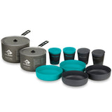 The Sea to Summit Alpha Cookset 4.2 is a durable and lightweight camp kitchen set featuring high-spec anodized alloy pots with lids, four bowls, and four insulated cups with lids, all neatly arranged.