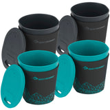Four black and teal reusable cups with lids, included in the "Sea to Summit Alpha Cookset 4.2" set, are arranged in a group. Three cups have lids propped on the side, while one lid rests on top. This durable lightweight option is perfect for any camp kitchen set.