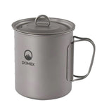 The Domex Titanium Pot is a lightweight camping mug with lid and folding handle, featuring the Domex logo and a mountain graphic—perfect for any camp cookware collection.