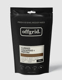 A black resealable pouch labeled "Offgrid Curried Chickpeas & Pepitas" by Offgrid features adventure ready and gluten free icons, aromatic spices, Australian made status, and a 300g net weight displayed.
