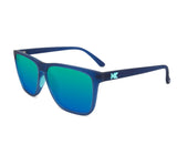 A pair of Knockaround Fast Lane Sport Sunglasses featuring blue-green reflective, polarized lenses and a "K" logo on the temple, offering excellent UV protection.