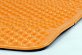 A close-up of an orange textured closed-cell foam mat with raised bumps, perfect for ultralight backpacking and alpinism adventures, the Exped Flexmat by Exped.