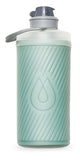 The HydraPak Hydrapak Flux Bottle 1L is light green, flexible, features a diagonal striped texture, a droplet design on the front, and a gray spill-proof twist cap.