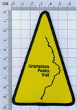 Yellow triangular GPT Route Map Trail Marker Woven Patch featuring the outline of Grampians Peaks Trail (GPT), measured against a ruler for scale by Absolute Outdoors.