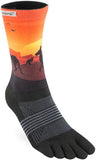 The Injinji Women's TRAIL Midweight Crew by Injinji features a sunset and kangaroo design with black and gray stripes, offering perfect moisture-wicking for women’s trail running.