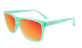 Knockaround Fast Lane Sport Sunglasses with teal frames and orange mirrored, polarized lenses offering UV protection and a small orange "K" logo on the left temple.
