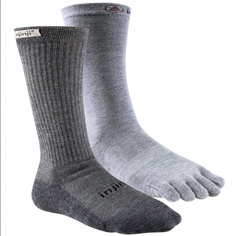 A pair of Injinji Outdoor Hiker & Liner Men's Crew socks with grey toes for a hiking adventure.
