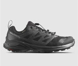 A single black Salomon X Adventure GTX Men's hiking shoe with a visible logo and contagrip sole, displayed against a gray background.