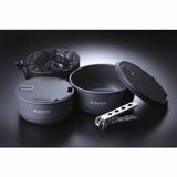 The Soto Navigator Camping Cookware Set by Soto includes two pots with lids, a metal pot gripper, and a black mesh storage bag—ideal outdoor cooking gear arranged on a dark surface.