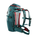 A Tatonka Hike Pack made from recycled materials, featuring multiple adjustable straps, a ventilated back panel, and red accents.