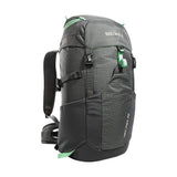 A gray and black Tatonka Hike Pack with green accents. It features multiple compartments, adjustable straps, and a grid pattern on the front pocket. The brand name "Tatonka" is visible at the top, and it boasts a ventilated mesh back panel for added comfort.