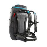 A Tatonka Hike Pack crafted from recycled materials, featuring multiple compartments, padded straps, and a waist belt, shown in a standing position with its ventilated mesh back panel and shoulder straps visible.