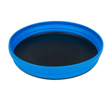 The Sea to Summit X Plate by Sea to Summit is a round black plate with a blue, BPA-free collapsible silicone rim, fully expanded against a white background.