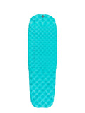A turquoise, Sea to Summit Comfort Light Air Sprung Mat with a textured surface and rounded edges, designed for outdoor camping. Featuring Air Sprung Cells for extra coziness and a multi-function high flow-rate valve for easy inflation and deflation.
