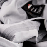 A close-up of crumpled gray fabric with a visible black clothing label containing text. The texture suggests it could be Hydronaute fabric, ideal for a Mont Men's Austral JKT by Mont thanks to its waterproof breathable properties.