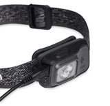The Black Diamond Astro 300 Rechargeable Headlamp features an adjustable strap, delivers 300 lumens of brightness, and includes a connected charging cable for easy recharging.