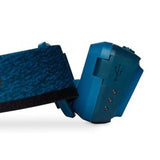 A blue wristband featuring a USB connector and three small metallic contacts, set against a white background, evokes the sleek design characteristic of the Black Diamond Astro 300 Rechargeable Headlamp by Black Diamond.
