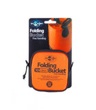 A packaged Sea to Summit Folding Bucket. The orange and black package indicates it is a free-standing, 10-liter bucket for carrying and storing water. Made of food grade coated fabric, it features an easy pouring handle. Labels specify "Sea to Summit Folding Bucket" and "10 Litres.