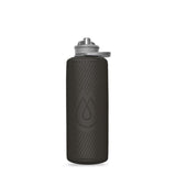 The Hydrapak Flux Bottle 1.5L, a lightweight black bottle, features a textured surface with a high flow nozzle for easy sipping and comes with a flip-top lid.