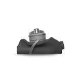 A gray Hydrapak Flux Bottle 1.5L, lightweight and compact with a high flow nozzle for seamless hydration, rests on a dark textured fabric backdrop.