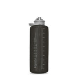 The Hydrapak Flux Bottle 1.5L is a transparent dark bottle with a gray lid featuring volume measurements and the Hydrapak logo, and it boasts a high flow nozzle for easy hydration.
