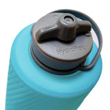 A close-up of the blue Hydrapak Flux Bottle 1.5L highlights its lightweight and compact design, featuring a gray lid with a foldable spout and high-flow nozzle for quick hydration.