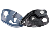 Climbing belay device branded as "Petzl Gri Gri," featuring an assisted braking mechanism in black and silver, with a blue-gray safety attachment point. Designed for use with single ropes.