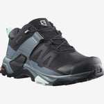 A black and grey hiking boot with blue accents featuring a waterproof Gore-Tex label, stability support, and the Salomon brand logo designed women-specific.