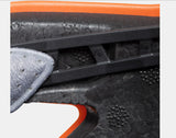 Close-up of the Mammut Skywalker 3.0 black shoe sole with an orange edge, textured surface, and a black plastic component designed for impact protection. A portion of the gray upper material from Mammut is also visible.