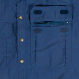 A close up of a blue shirt with pockets, featuring Mont Men's Lifestyle Vented Shirt with Bug-Off anti-mosquito repellent.