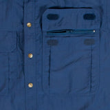A close up of a blue shirt with pockets, featuring Mont Men's Lifestyle Vented Shirt with Bug-Off anti-mosquito repellent.