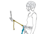 A woman engaged in sport climbing, wearing a helmet and utilizing a Petzl Connect Adjust on her adjustable arm.