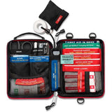Open the Survival Handy First Aid Kit by Survival First Aid, revealing an array of medical supplies such as bandages, scissors, gloves, antiseptic wipes, an emergency blanket, and a first aid booklet.