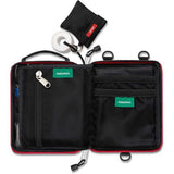 Open black Survival Handy First Aid Kit by Survival First Aid, featuring various zippered compartments, pockets labeled "PERSONAL," and a mesh pouch containing a roll of tape, an emergency blanket, and a knit cover with a red tag.