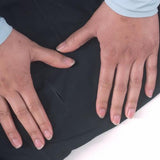 Two hands rest on Gear Aid Gore-Tex Fabric Patches, palms down.