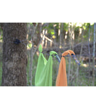 Two towels hanging on a Sea to Summit clothesline outdoors with trees in the background.