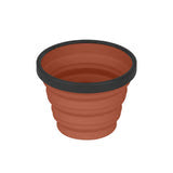 A brown, ribbed Sea to Summit X Cup 250ml with a black rim, reminiscent of a compact flower pot in its sleek design.