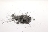 A small pile of Grimpi Coloured Chalk Sock 100g scattered on a white surface by Absolute Outdoors.