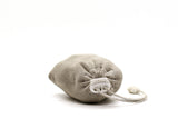 A small, grey eco-friendly drawstring pouch lying on a white background containing Grimpi Coloured Chalk Sock 100g by Absolute Outdoors.