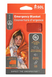 The SOL Emergency Blanket by SOL is packaged and made of Heatsheets® material, with a photo of a person in an orange reflective blanket and product info in English and French on the front.