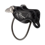 The DMM Pivot Belay Device by DMM is a black climbing belay device with engraved markings and a metallic loop, featuring a guide mode for added versatility and used for controlling ropes in rock climbing.