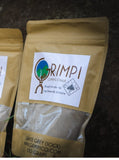 Packages of Absolute Outdoors Grimpi Coloured Chalk Sock 100g displayed against a dark background.