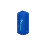 A blue Sea to Summit Lightweight Stuff Sack made from durable nylon, featuring the brand logo and name printed vertically. The cylindrical sack has a drawstring closure at the top and offers water-resistant protection, perfect for modular packing.