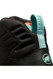 Close-up image of a black Mammut Women's Sapuen High GTX Hiking Boot with "Swiss Design" written on a teal pull tab at the heel, a small logo of a mammoth, and featuring a durable Vibram® sole perfect for hiking.