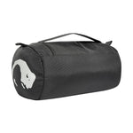 Rounded black Tatonka Care Barrel Wash Bag with a handle on top, featuring a white animal silhouette logo on the side and an integrated hanging hook for easy storage.