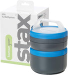 Blue-lidded stackable lunch containers in front of a Sea To Summit Humangear Stax box with green and gray text.