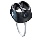 The Black Diamond ATC, in black, is a belay device with two slots and a silver loop for attaching a rope, providing smooth-handling geometry that is perfect for both belaying and rappelling.