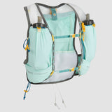 A light blue and white hydration vest equipped with multiple pockets, breathable mesh panels, and two water bottles in holders on the front. The Ultimate Direction Race Vesta 6.0 features Comfort Cinch 3.0 adjustable straps and various attachments for securing gear from Ultimate Direction.