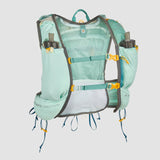 The Ultimate Direction Mountain Vesta 6.0 hydration backpack in light blue and gray offers ample storage with multiple pockets, water bottle holders, adjustable straps, and trekking pole options. Ideal for adventurers, it features a plain background design.