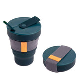 The Hunu Collapsible Cup by Hunu is a BPA-free dark green travel cup with a leak-proof lid, straw, and gray fabric grip, shown both expanded and folded.